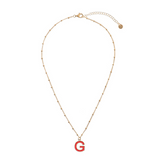 Necklace with ball chain and fuchsia enamel initial
