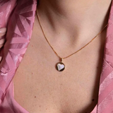 Necklace with circle pendant and heart inside