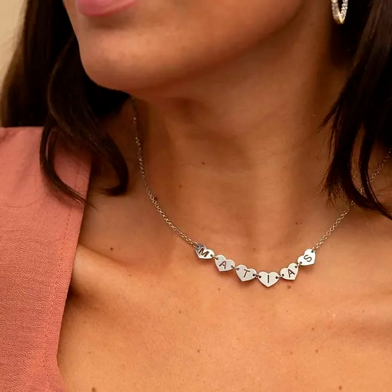 Necklace with perforated hearts with letters