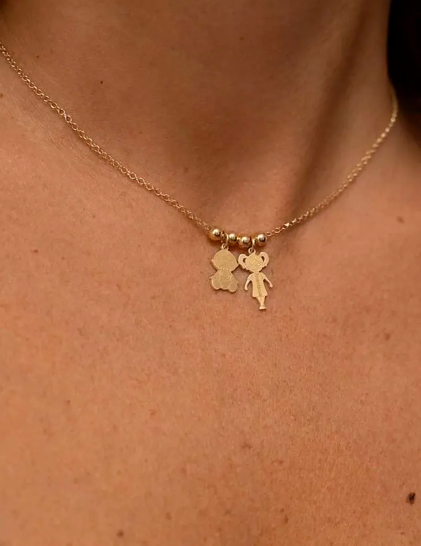 Necklace with two doll pendants and engravings